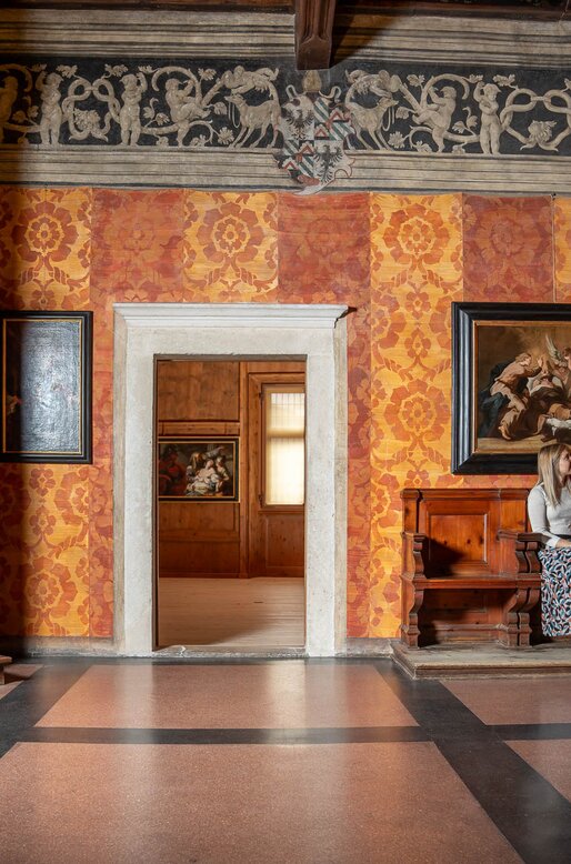 Ragazza seduta vicino alla scala nel Palazzo della Magnifica Comunità di Fiemme | © APT Fiemme e Cembra - foto di Mattia Rizzi