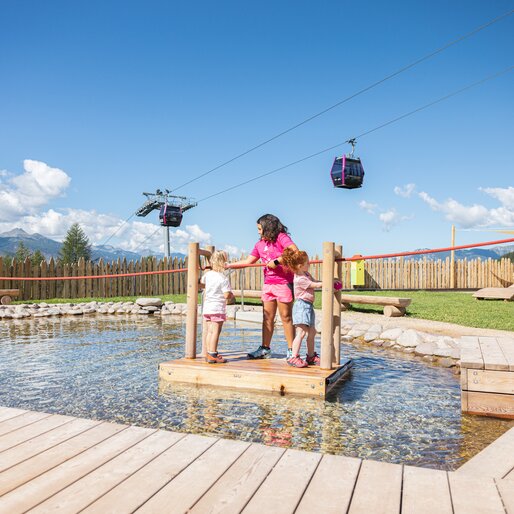 Tre bambine sulla zattera del laghetto al parco Giro d'Ali | © APT Fiemme e Cembra - Gaia Panozzo